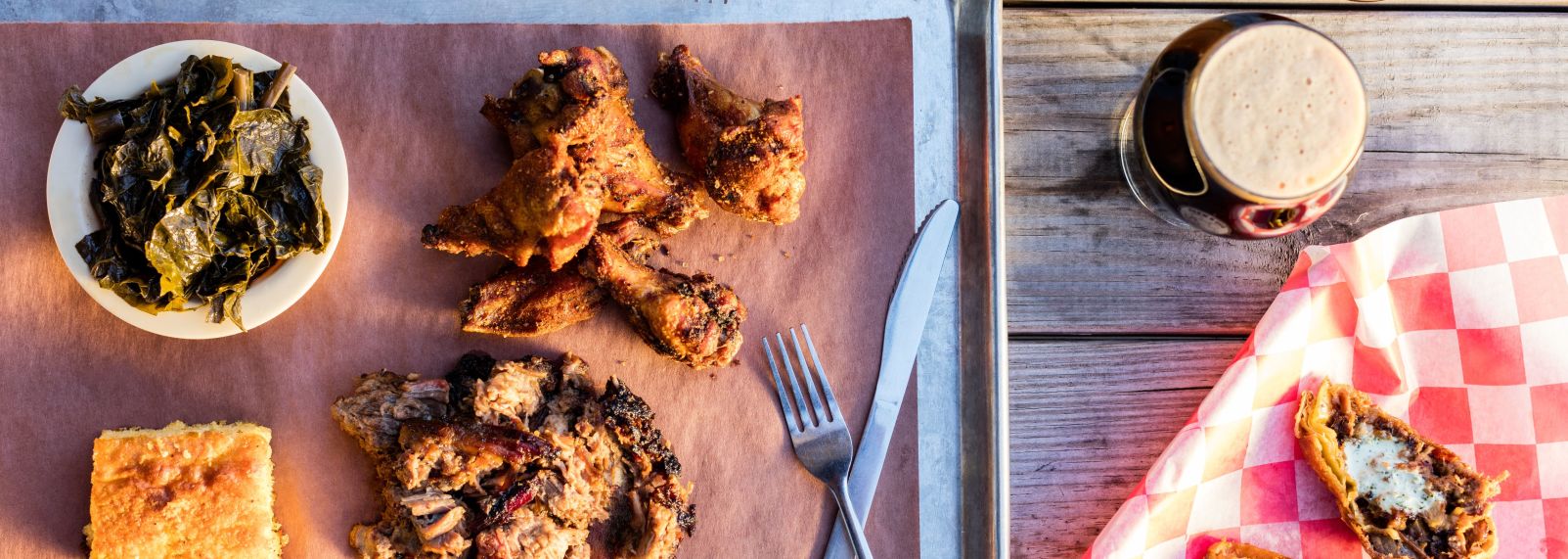 Brew N Que tray of chicken, spinach, cornbread and pulled pork with beer and potato skins on the side